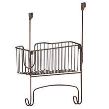 Load image into Gallery viewer, mDesign Metal Over Door Ironing Board Holder with Large Storage Basket - Holds Iron, Board, Spray Bottles, Starch, Fabric Refresher - for Laundry, Utility Room, Garage - Bronze
