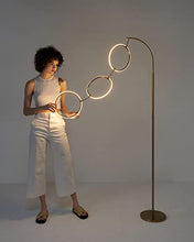 Load image into Gallery viewer, Brightech Nova Modern Floor Lamp - Contemporary Arc Tall Lamp with 3-Circle Ring-Style Pendant - Over The Couch Standing Lamp on Arching Pole - Eclectic Tall Lamp Matches Living Room Décor - Gold
