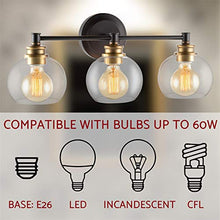 Load image into Gallery viewer, Kira Home Odette 22" Modern 3-Light Vanity/Bathroom Light + Clear Glass Globe Shades, Warm Brass Accents + Oil Rubbed Bronze Finish
